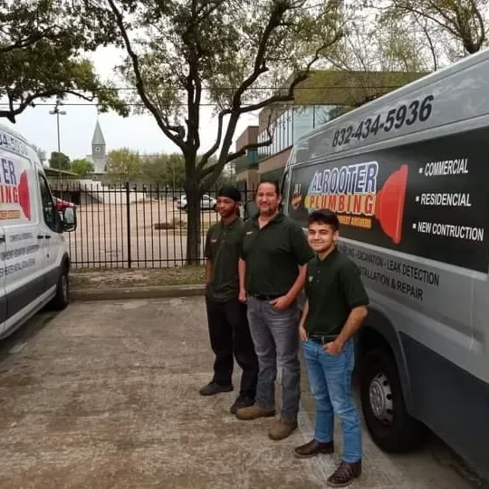AL Rooter Plumbing technicians beside a company van