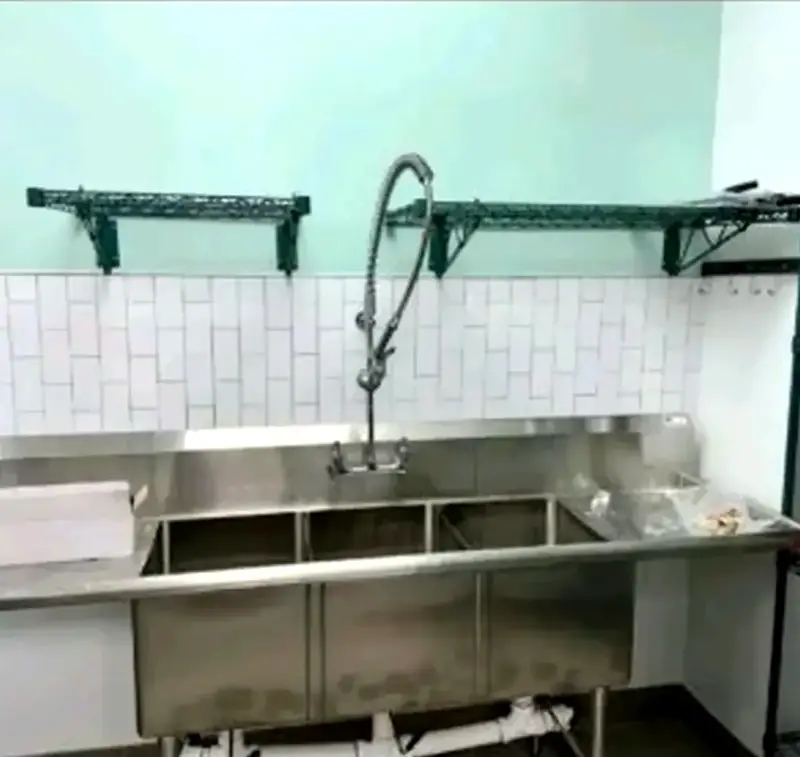 Commercial three compartment sink installation